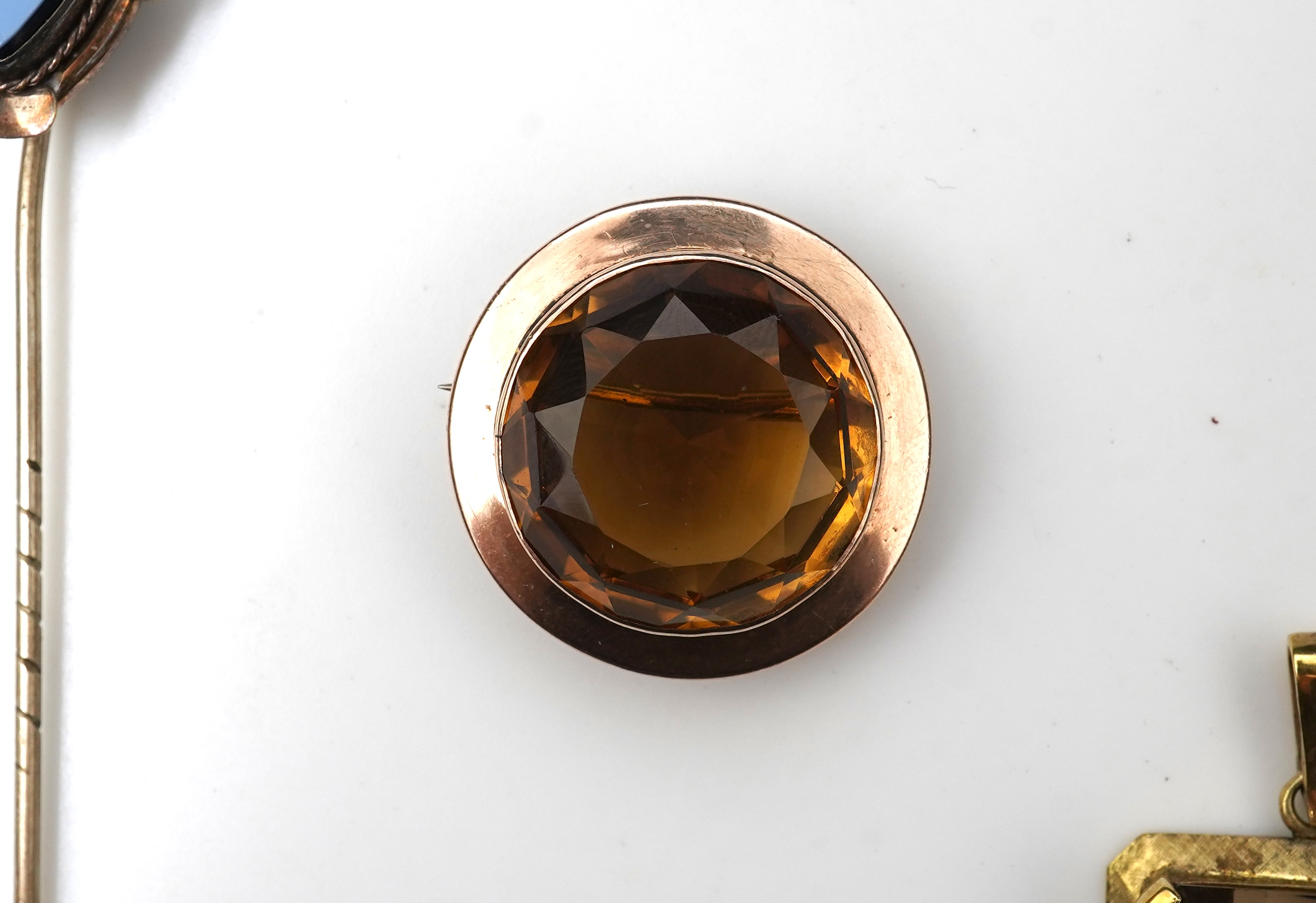 A citrine brooch and pendant, and onyx stickpin